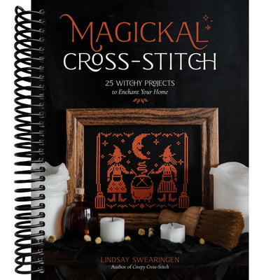 Book titled 'Magickal Cross-Stitch' with cross-stitch design and witch-themed decor on cover